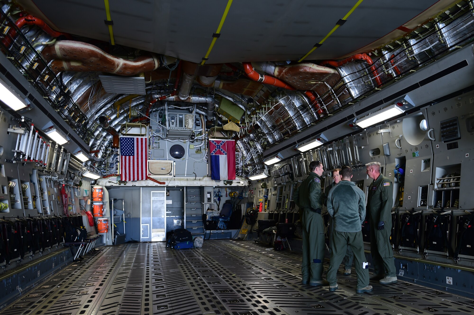Loadmasters, from the 172nd Airlift Wing, discuss cargo procedures March 15, 2016, on Buckley Air Force Base, Colo. The loadmasters assisted the 140th Wing load equipment that will be used in an exercise taking place at Tyndall AFB, Florida.(U.S. Air Force photo by Airman 1st Class Luke W. Nowakowski/Released)