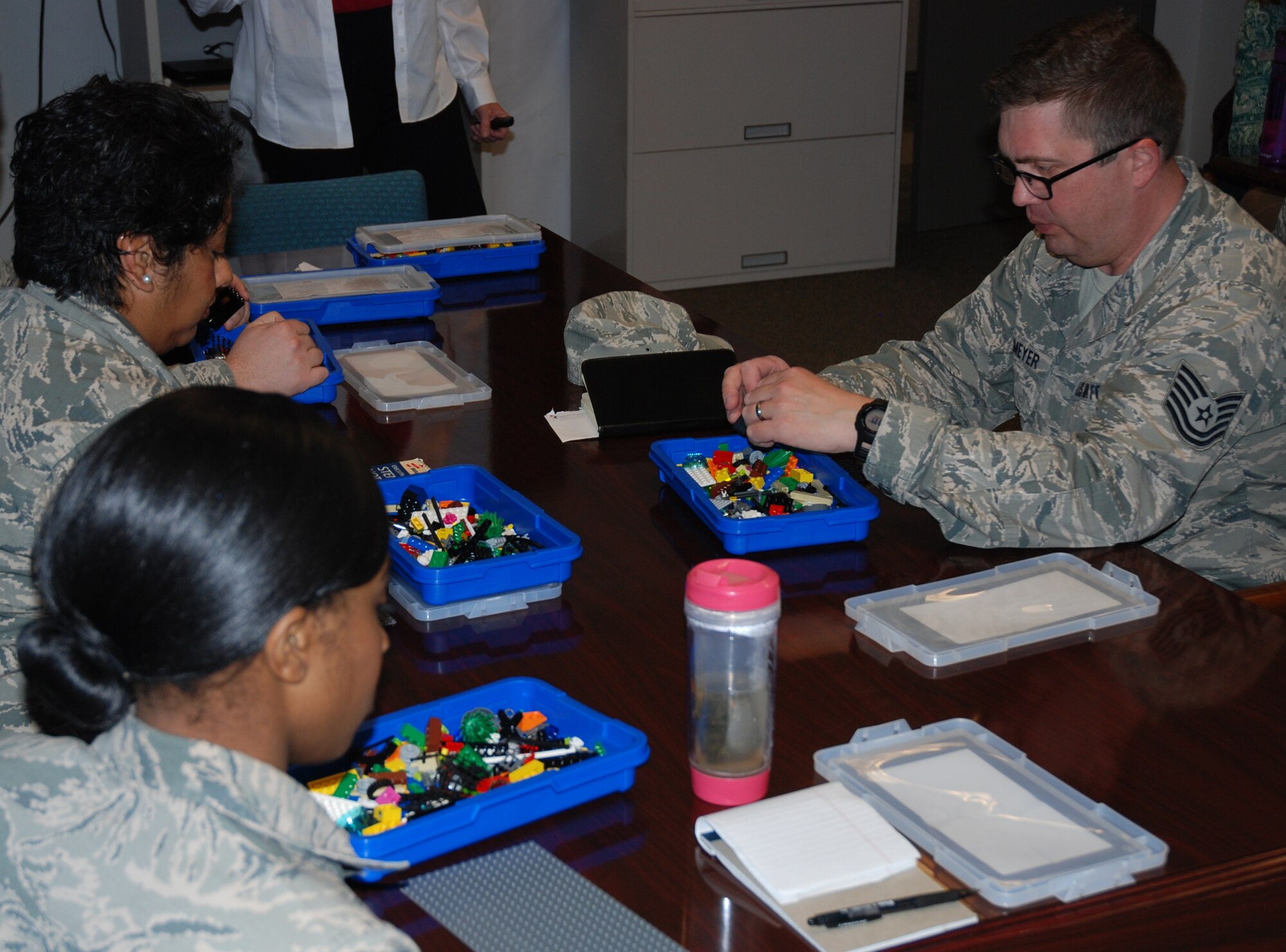PETERSON AIR FORCE BASE, Colo. – 21st Space Wing unit resiliency trainers work on models using LEGO bricks to express something they did before coming to the training March 9, 2016. LEGO Education Global Trainer Kelly Reddin trained the group in using LEGO bricks to help instill resiliency skills in Airmen. (U.S. Air Force photo by Dave Smith)