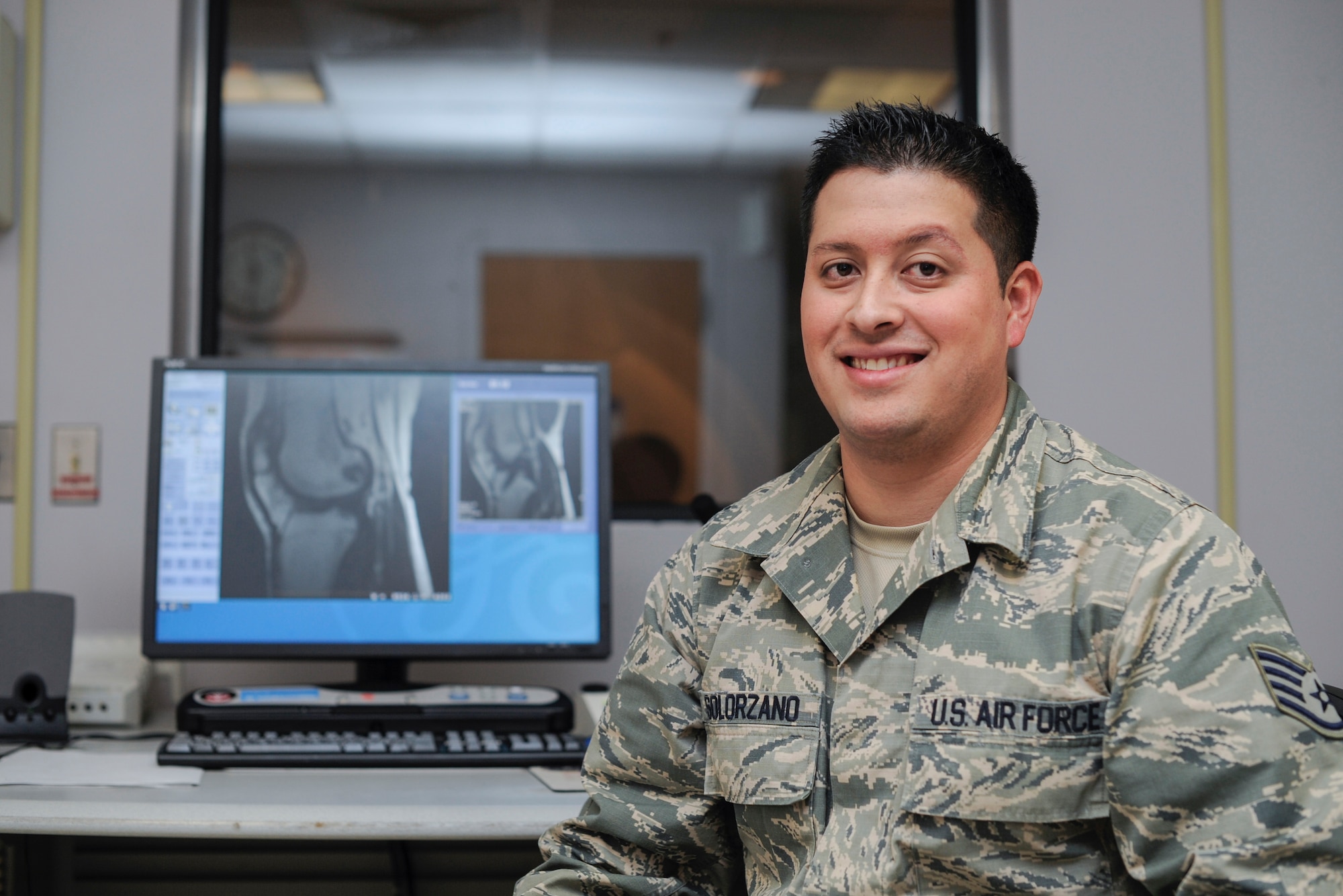 Staff Sgt. Adrian Solorzano, 779th Medical Group Magnetic Resonance Imaging section NCO in-charge, poses for a photo during an MRI scan at Malcolm Grow Medical Center on Joint Base Andrews, Md., March 17, 2016. MRIs help diagnose a variety of disorders that could hinder the patients and ultimately the mission. (U.S. Air Force photo by Senior Airman Ryan J. Sonnier/RELEASED)