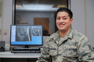 Staff Sgt. Adrian Solorzano, 779th Medical Group Magnetic Resonance Imaging section NCO in-charge, poses for a photo during an MRI scan at Malcolm Grow Medical Center on Joint Base Andrews, Md., March 17, 2016. MRIs help diagnose a variety of disorders that could hinder the patients and ultimately the mission. (U.S. Air Force photo by Senior Airman Ryan J. Sonnier/RELEASED)