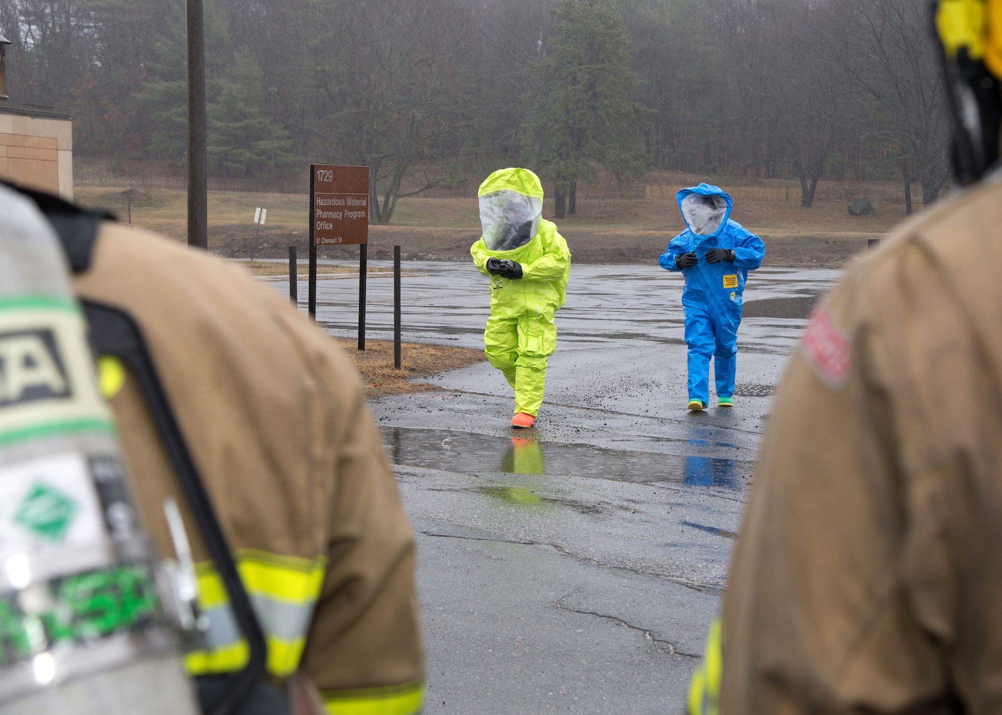 Brent Nagele, 66th Civil Engineering Division Emergency Management team member, left, and Norman Geis, 66th Medical Squadron bioenvironmental engineer, participate in an emergency management exercise on base March 15. Nagele and Geis exercised collecting samples of a simulated substance that was found outside Building 1729 as part of the scenario. Throughout the week, the base performed various scenarios to evaluate the installation's readiness and emergency response capabilities. (U.S. Air Force photo by Mark Herlihy)