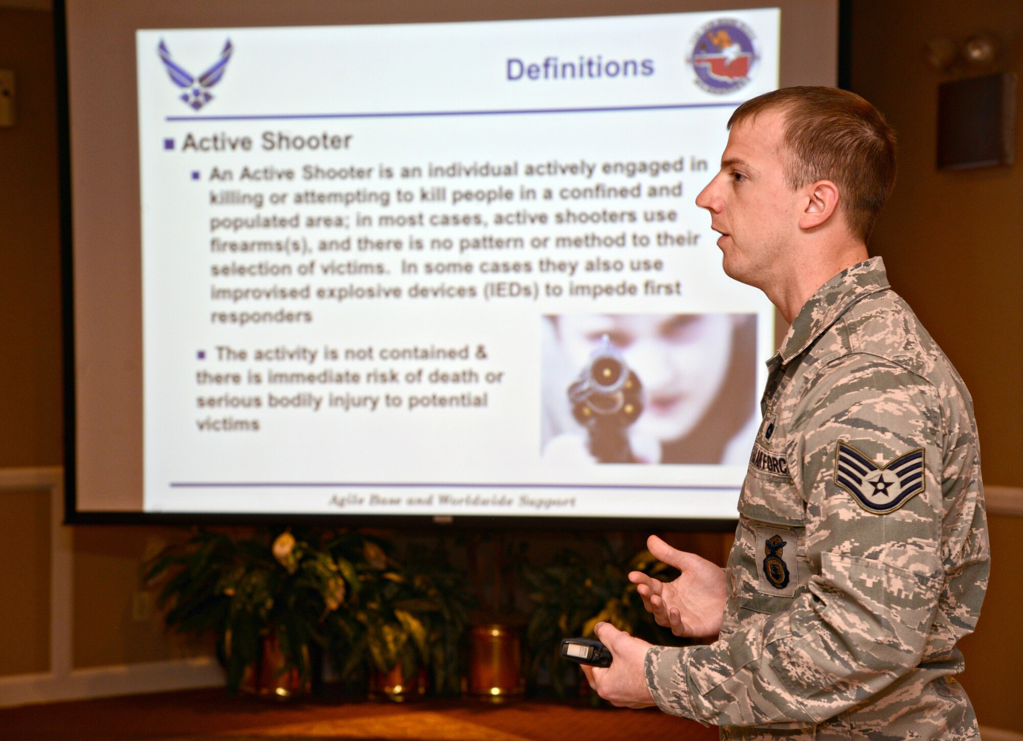 Staff Sgt. Joseph Jones, with the 72nd Security Forces Squadron, speaks to attendees at a March 9 Town Hall meeting about what procedures to follow in case of an active shooter. The 72nd SFS was tasked with holding this town hall meeting discussing severe weather and active shooter procedures as a direct result of particular interest in these topics from a previous town hall meeting. (Air Force photo by Kelly White)