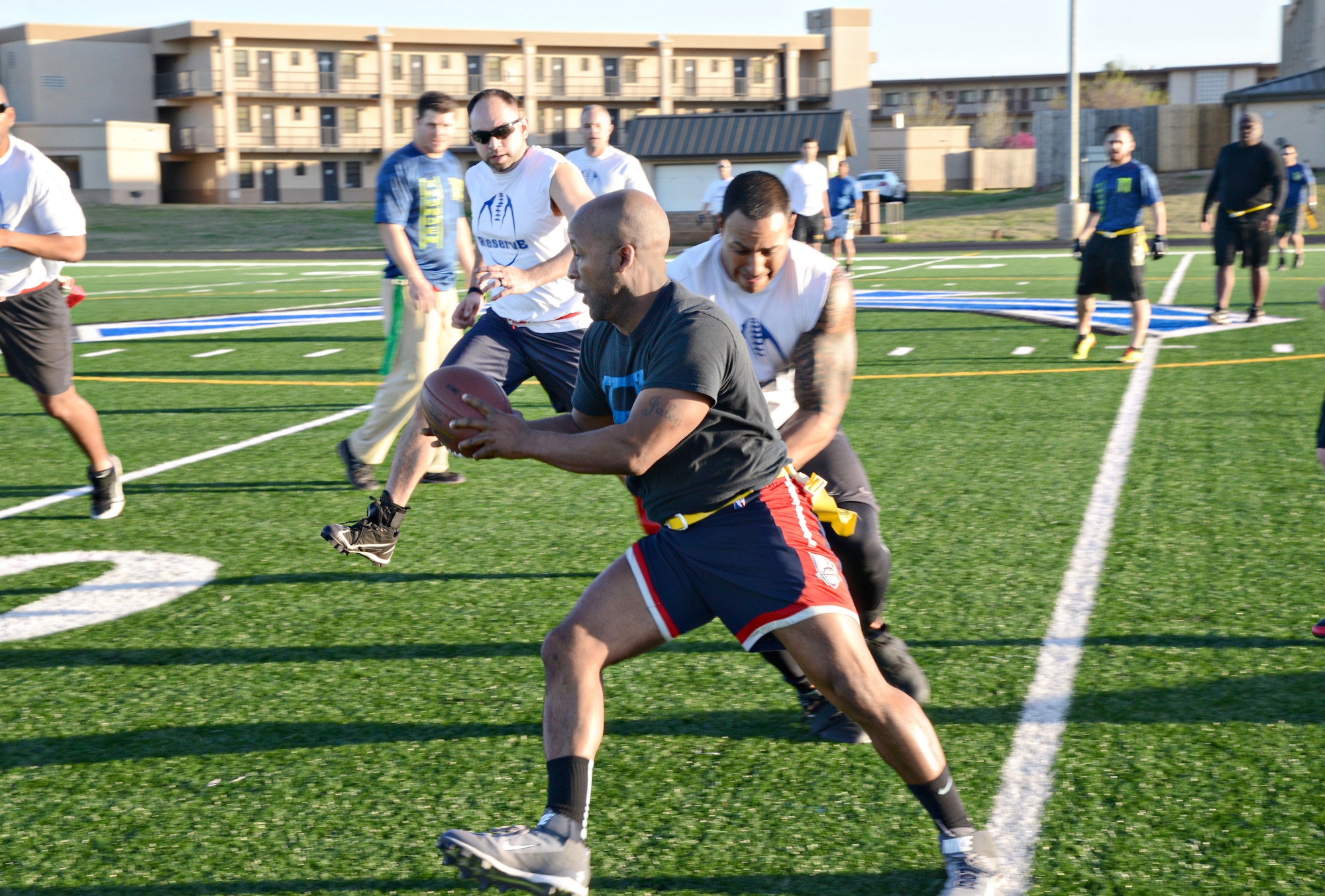 Reserve White’s Floyd Conner tries to pull the flag from Tropic Thunder’s Michael Elliott during Tuesday night’s matchup. Reserve White won 14-12. (Air Force photo by Kelly White)