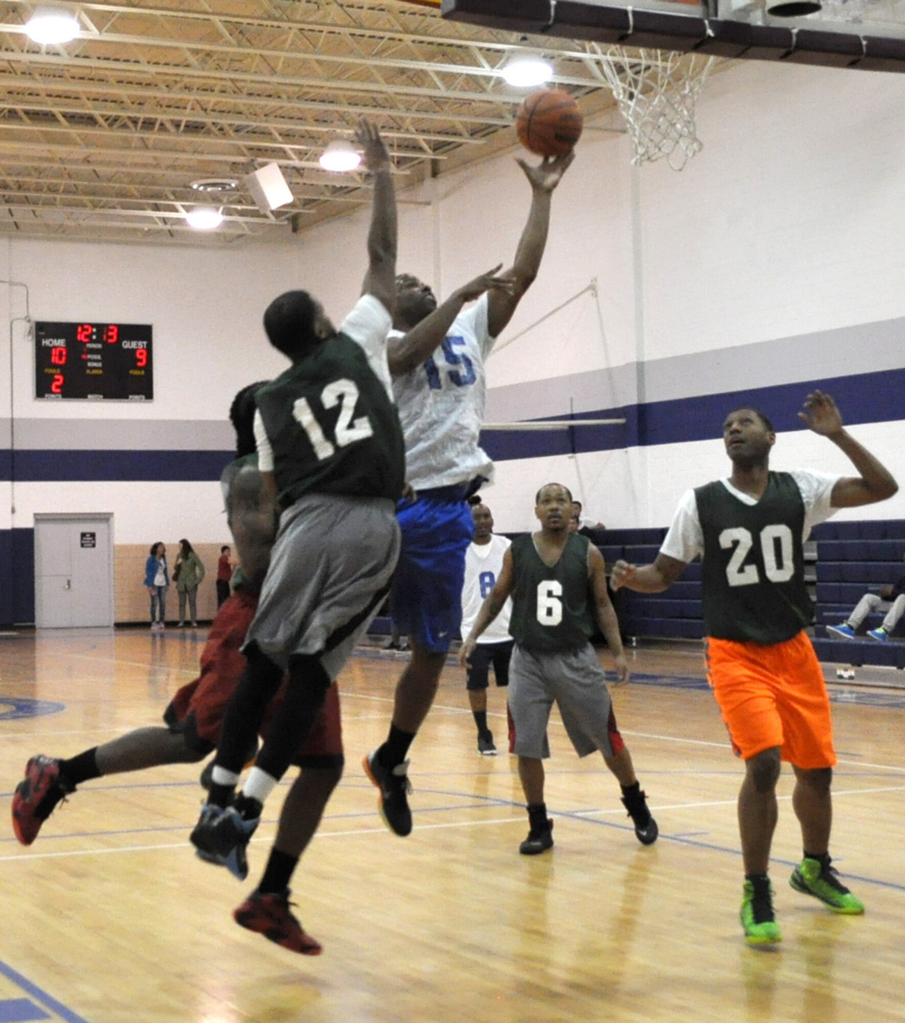 Michael McCray of Flight Controllers gets the edge on 72 MDG defenders March 7 for a layup at the Gerrity Fitness Center. Med Group threatened to topple Flight Controllers’ undefeated season in a squeaker the Controllers won 56-55. (Air Force photo by John Parker)