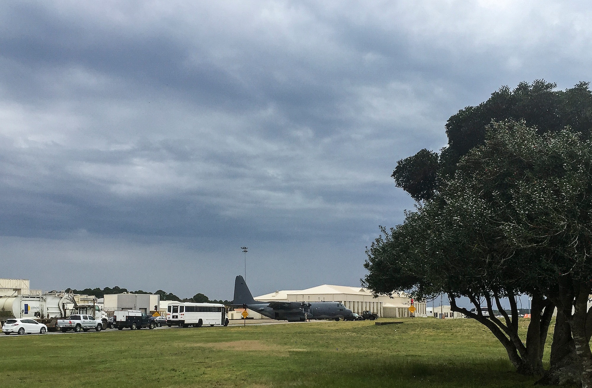 Under stormy skies, traffic stops on Eglin Boulevard as a C-130 is towed across the base’s main street to the 96th Test Wing flightline March 17 at Eglin Air Force Base, Fla.  (U.S. Air Force photo/Samuel King Jr.) 