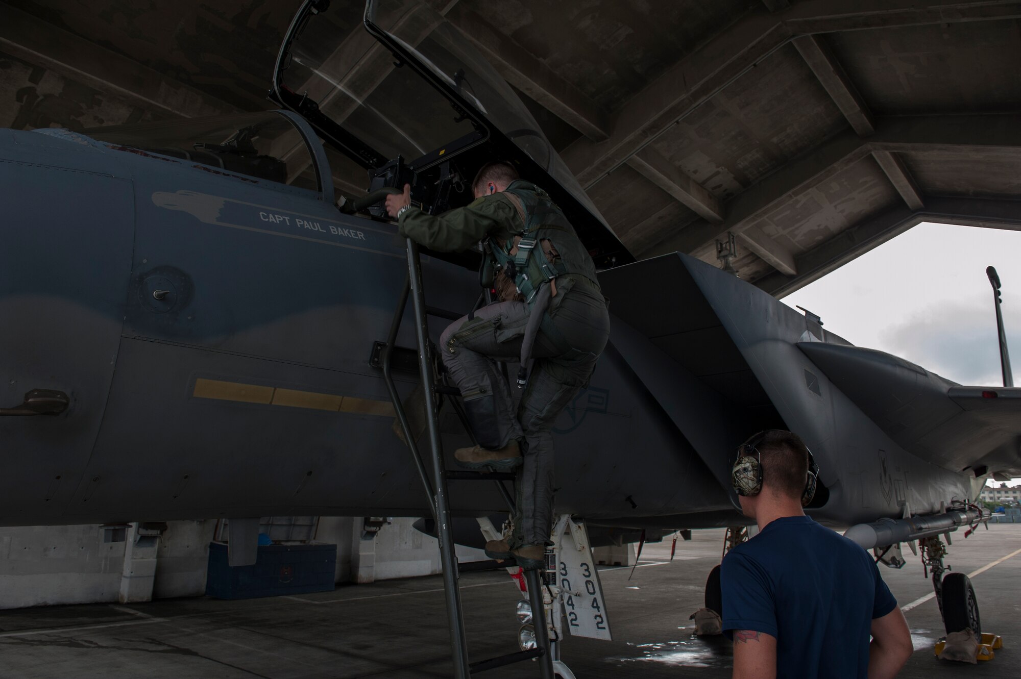 U.S. Navy Lieutenant Dustin Henze, 44th Fighter Squadron Navy exchange pilot, climbs into an F-15 Eagle March 18, 2016, at Kadena Air Base, Japan. Pilots participated in readiness training and demonstrated how fast they could get into their aircraft and be ready to fly at a moment’s notice. (U.S. Air Force photo by Airman 1st Class Lynette M. Rolen)