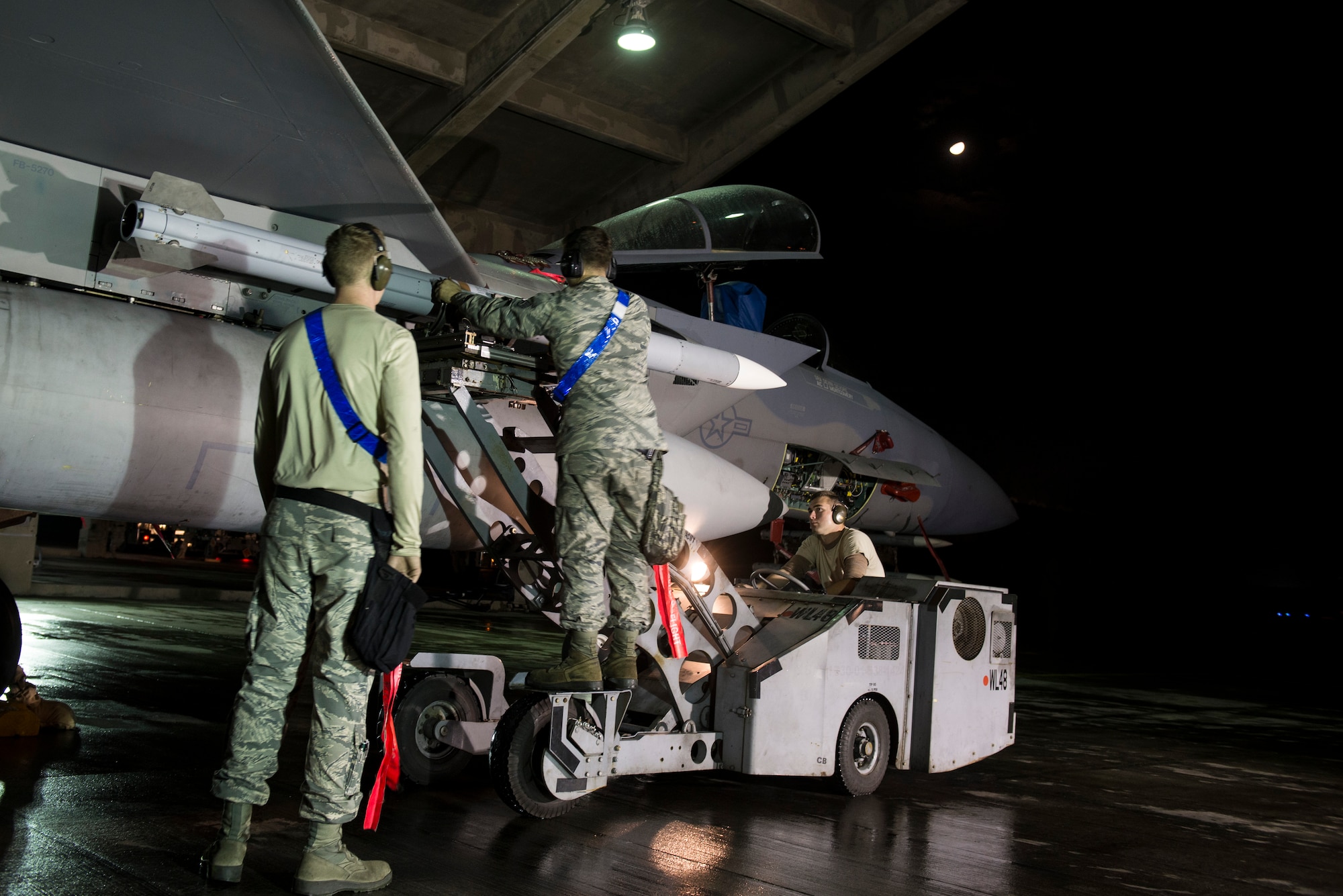44th Aircraft Maintenance Unit weapons loaders arm an F-15 Eagle with AIM-9X Sidewinder missiles during a no-notice exercise March 18, 2016, at Kadena Air Base, Japan. 18th Wing Airmen train night or day to be able to rapidly respond to any situation. (U.S. Air Force photo by Senior Airman Omari Bernard)