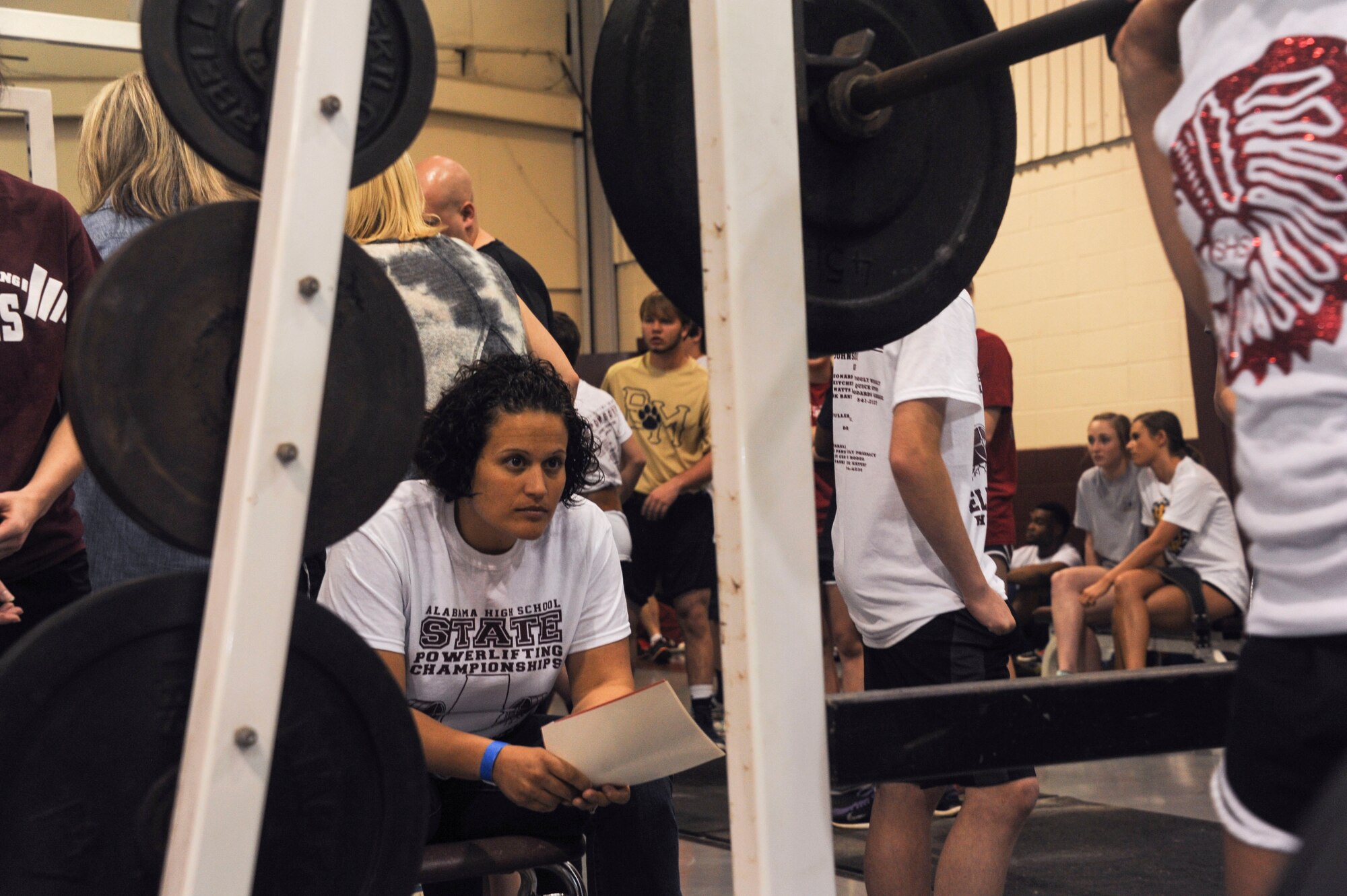 Capt. Andrea Gallegos, Holm Center curriculum area manager, judges the form of an athlete during the Alabama State Powerlifting Championships March 12, 2016, at Eclectic, Alabama. There were 31 Maxwell Airman who volunteered to help the local high school put on their annual event. (U.S. Air Force photo by Airman 1st Class Alexa Culbert)