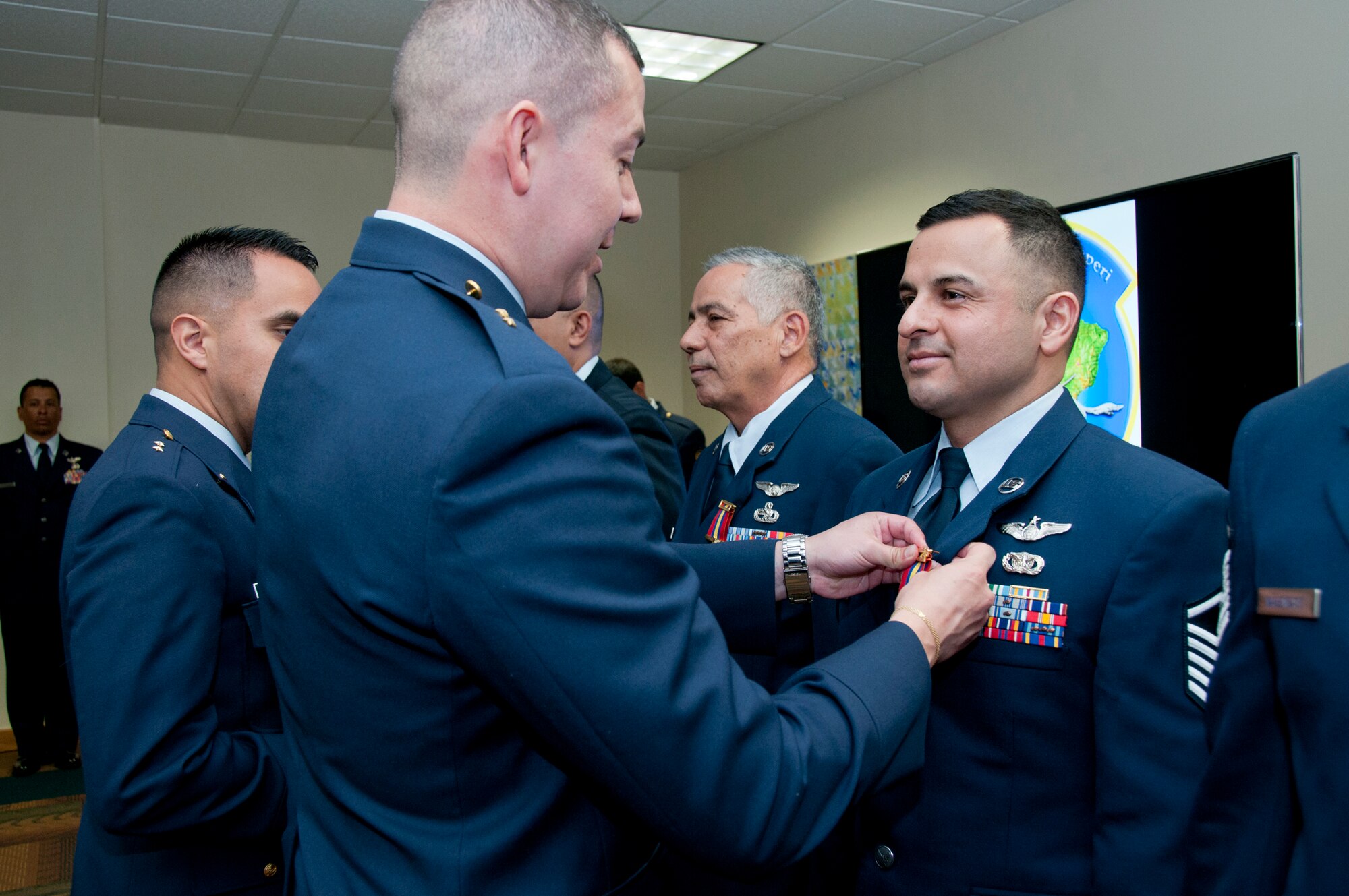 MIAMI - Colombian Air Force Lt. Edgardo J. Villamizar pins the Colombian Air Defense and Air Navigation medal here, March 4 on U.S. Air Force Master Sgt. Juan P. Castro, assigned to the I.G. Brown Training and Education Center. (U.S. Air National Guard photo by Master Sgt. Betty J. Squatrito-Martin/Released)