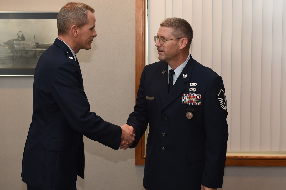 Tech Sgt. Daniel Christensen Promoted to Master Sgt. Lt. Col. Trenton Twedt congratulates newly promoted Master Sgt. Christensen. (U.S. Air National Guard photo by Staff Sgt. Matthew T. Doyle/Released)