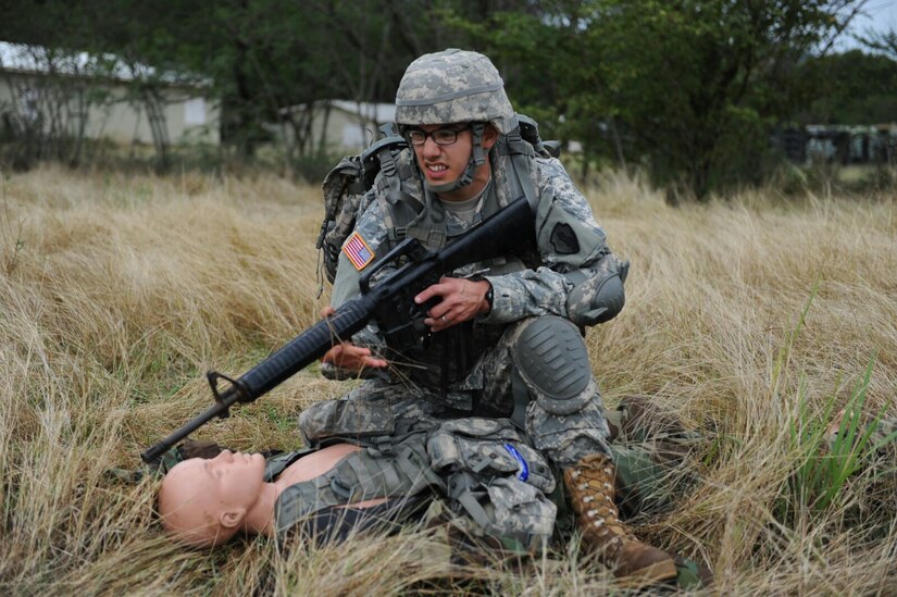 Spc. Janmichael Armijo, 35th ESB, C Co., protects a casualty during a MEDEVAC exercise at the 1st MSC Best Warrior Competition on Camp Santiago, Puerto Rico, March 15.