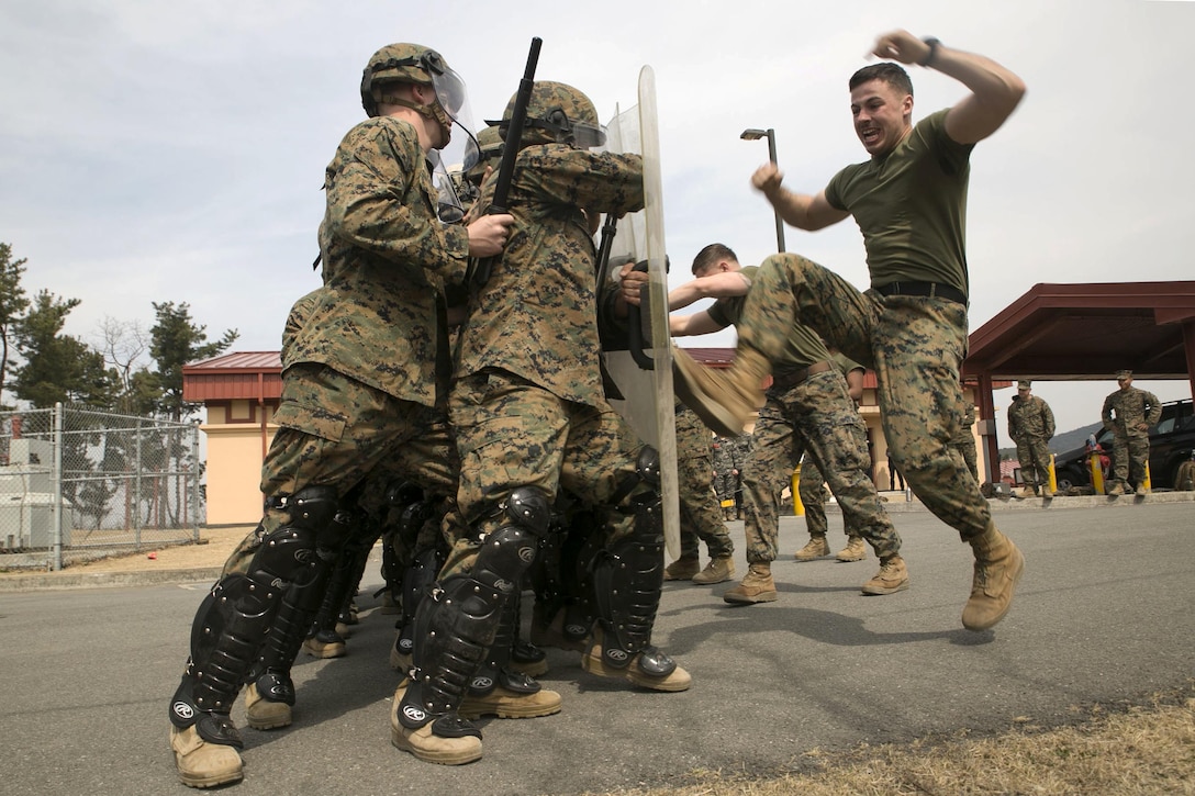 Marine Corps Cpl. Robert T. Sweeney role-plays as an aggressor during riot control training as part of Exercise Ssang Yong 16 on Camp Mujuk, South Korea, March 17, 2016. Sweeney is a military policeman with Charlie Company, 3rd Law Enforcement Battalion. The biennial amphibious exercise involves troops from the U.S., South Korea, Australia and New Zealand. Marine Corps photo by Staff Sgt. Jesse Stence