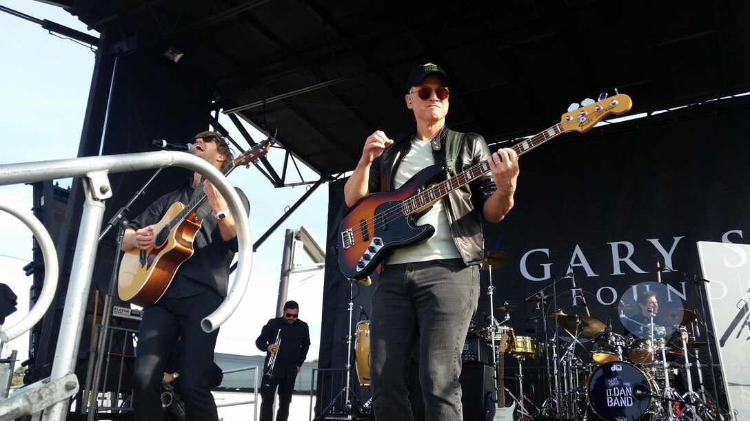 Actor Gary Sinise performs with the Lt. Dan Band during the Marine Corps Community Services Spring Carnival at the Wire Mountain Baseball Field here, March 20. The event was open to Marines, Sailors and their families. In addition to the performance, activities such as carnival rides, a petting zoo and a photo booth were also available at the event.