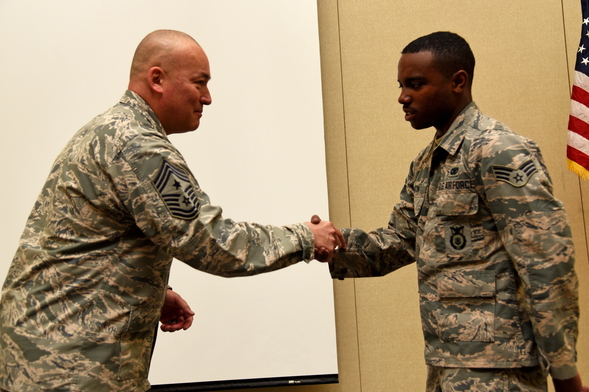 Chief Master Sgt. Mitchell O. Brush, the Senior Enlisted Advisor of the National Guard Bureau, coined Senior Airman Tyler Martin, 108th Security Forces Squadron, for his outstanding military service to the 108th Wing at the Joint Training and Training Development Center in Joint Base McGuire-Dix-Lakehurst, New Jersey, March 20, 2016. As the top noncommissioned officer of NGB, Brush advises the Chief, National Guard Bureau on all enlisted matters affecting training, effective utilization, the health of the force, and professional development for the National Guard. (U.S. Air National Guard photo by Tech. Sgt. Armando Vasquez/Released)