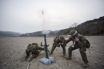 From left, U.S. Marine Corps Lance Cpl. Dave Hermansen and Lance Cpl. Jabril Giannotti, mortarmen, and Sgt. Jack Williams, a squad leader, all assigned to Weapons Co., Battalion Landing Team 1st Battalion 5th Marines, 31st Marine Expeditionary Unit, fire a 81mm training mortar with the M252A2 mortar system during Ssang Yong 16 at Suseongri, South Korea, March 15, 2016. Ssang Yong familiarizes American armed forces with the Korean Peninsula and contributes to the security and stability of the Asia-Pacific region. Hermansen is a native of Westbrook, Connecticut. Giannotti is a native of Highland Park, New Jersey. Williams is a native of Pilot Point, Texas. (Official U.S. Marine Corps photo by Cpl. Darien J. Bjorndal, 31st Marine Expeditionary Unit/ Released)