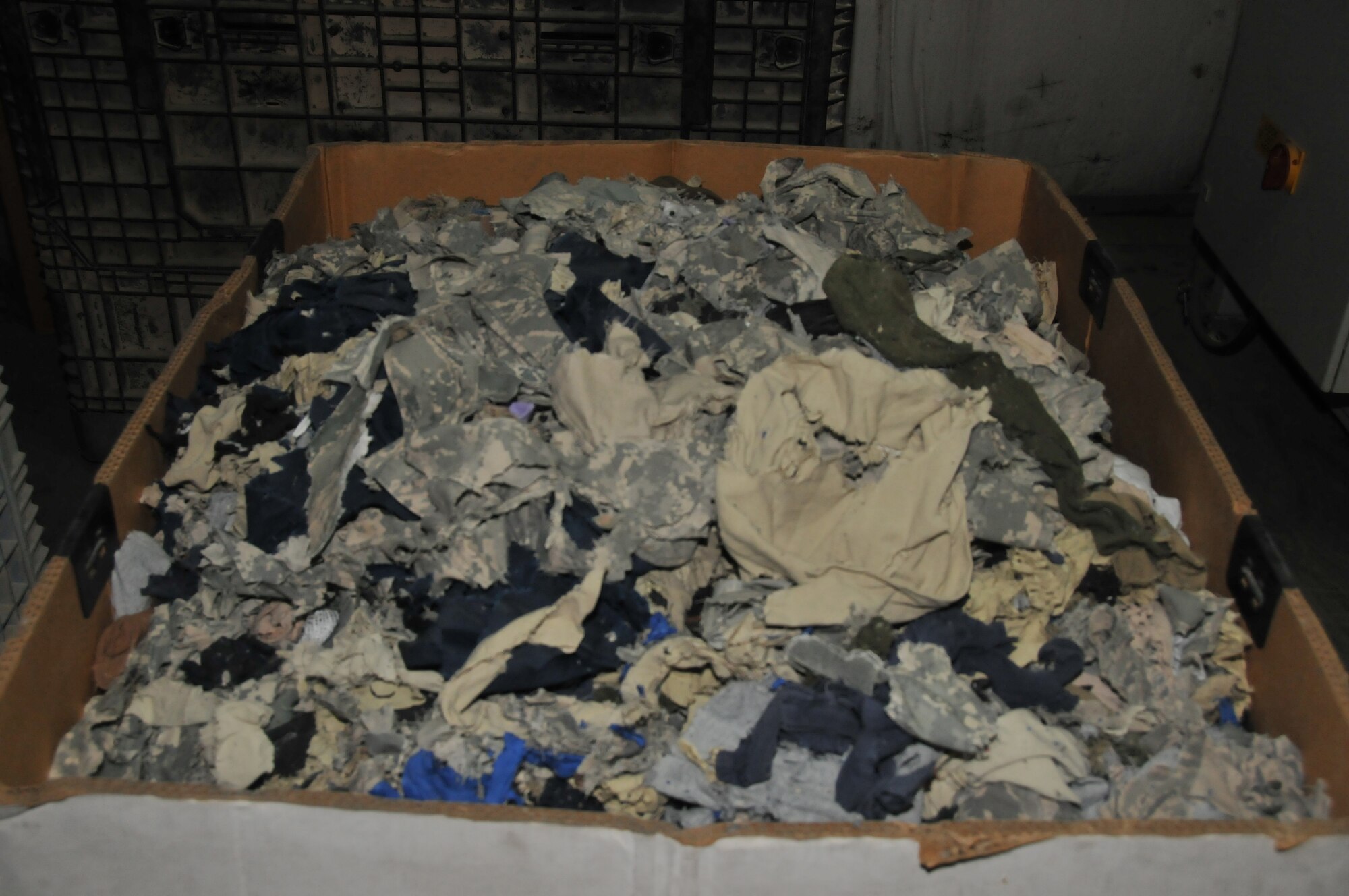 Uniforms are shredded weekly or bi-weekly depending on the changeover time at Al Udeid Air Base, Qatar. The AUABI 10-701 states how to properly dispose of uniforms on base. There are 15 bins located around the installation, four which are combined bins for both uniforms and paper. (U.S. Air Force photo by Tech. Sgt. Terrica Y. Jones)