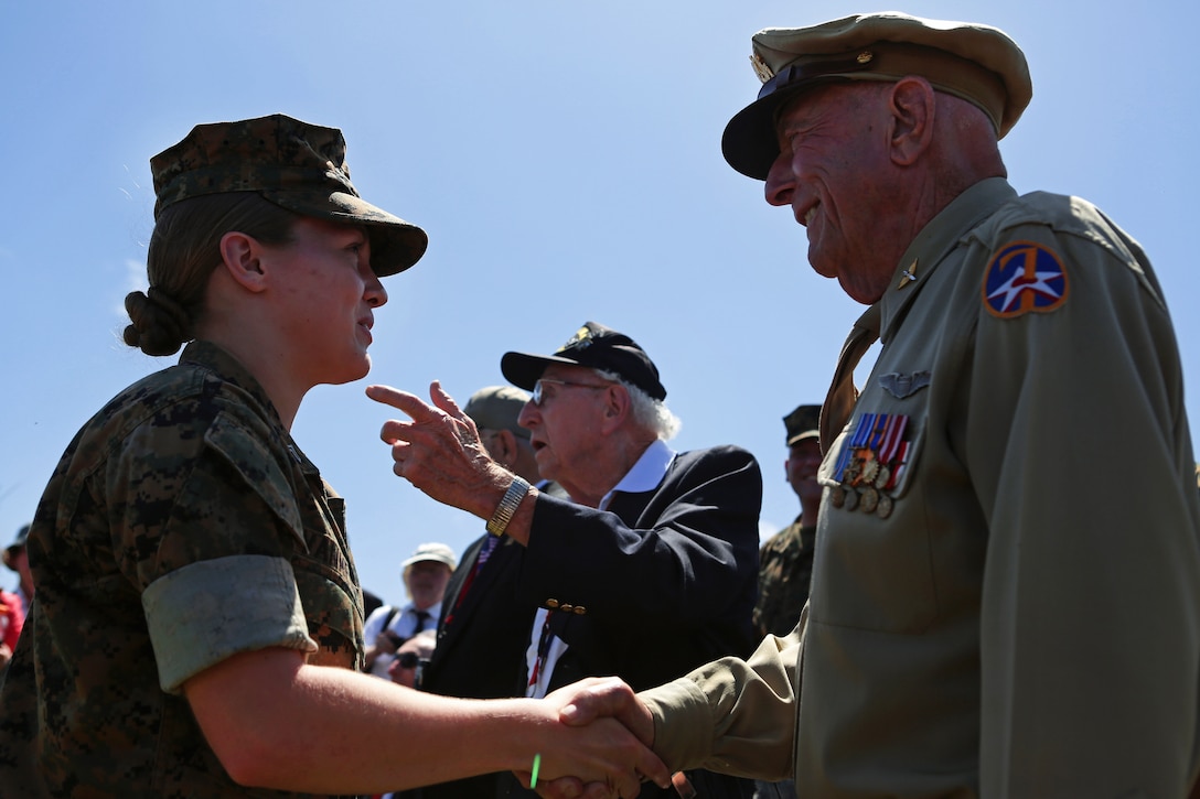 A Marine shakes the hand of retired Army Air Corps 1st Lt. Jerry Allen, at the 71st Commemoration of the Battle of Iwo Jima at Iwo To, Japan, March 19, 2016. Marine Corps photo by Lance Cpl. Juan Esqueda