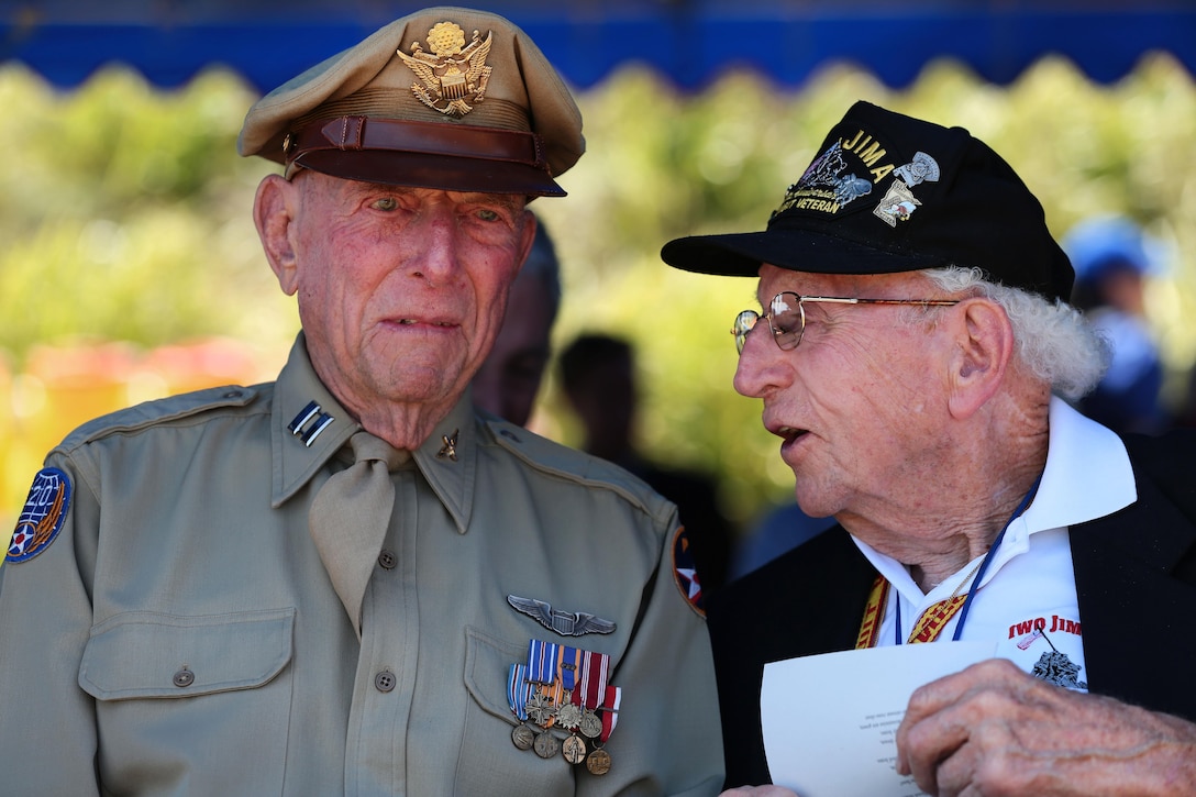 Retired Army Air Corps 1st Lt. Jerry Allen, left, listens to John Jack Lizere, a U.S. Marine Corps veteran of Iwo Jima, at the 71st Commemoration of the Battle of Iwo Jima at Iwo To, Japan, March 19, 2016. Marine Corps photo by Lance Cpl. Juan Esqueda