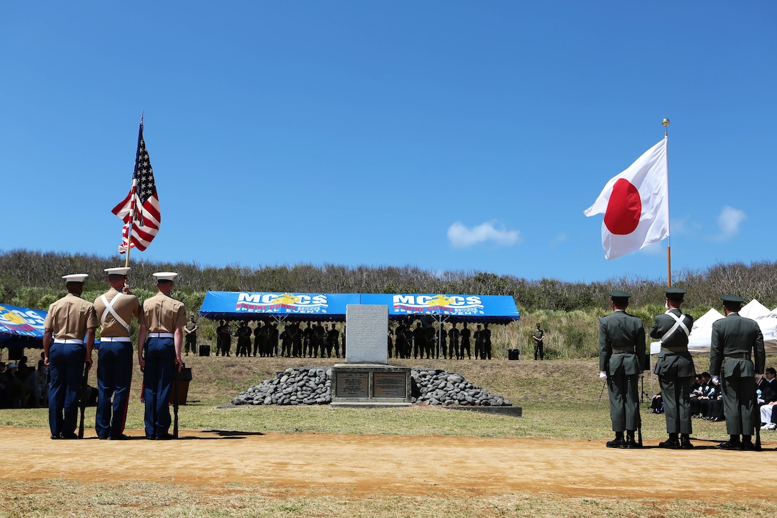 U.S. Marine Corps and Japanese army color guards stand at attention at the commencement of the 71st Commemoration of the Battle of Iwo Jima at Iwo To, Japan, March 19, 2015. Marine Corps photo by Lance Cpl. Juan Esqueda
