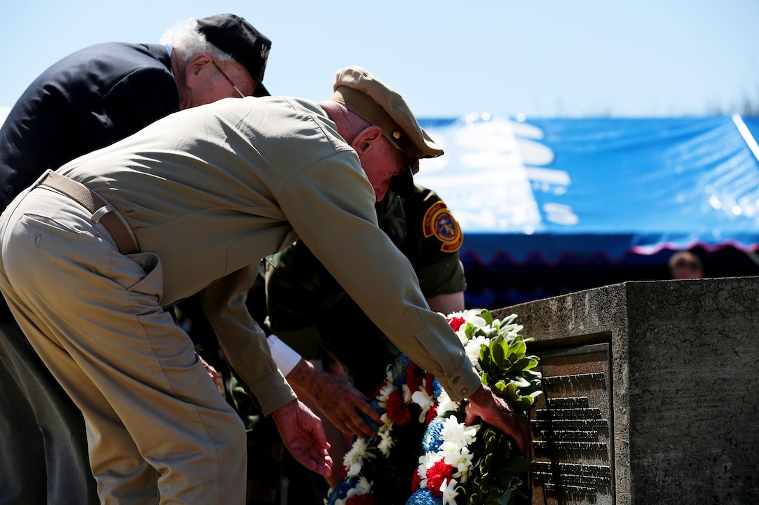 Retired U.S. Army Air Corps 1st Lt. Jerry Allen, foreground, and John Jack Lizere, a U.S. Marine Corps veteran of Iwo Jima lay a flower wreath at a monument during the 71st Commemoration of the Battle of Iwo Jima at Iwo To, Japan, March 19, 2015. Marine Corps photo by Lance Cpl. Juan Esqueda