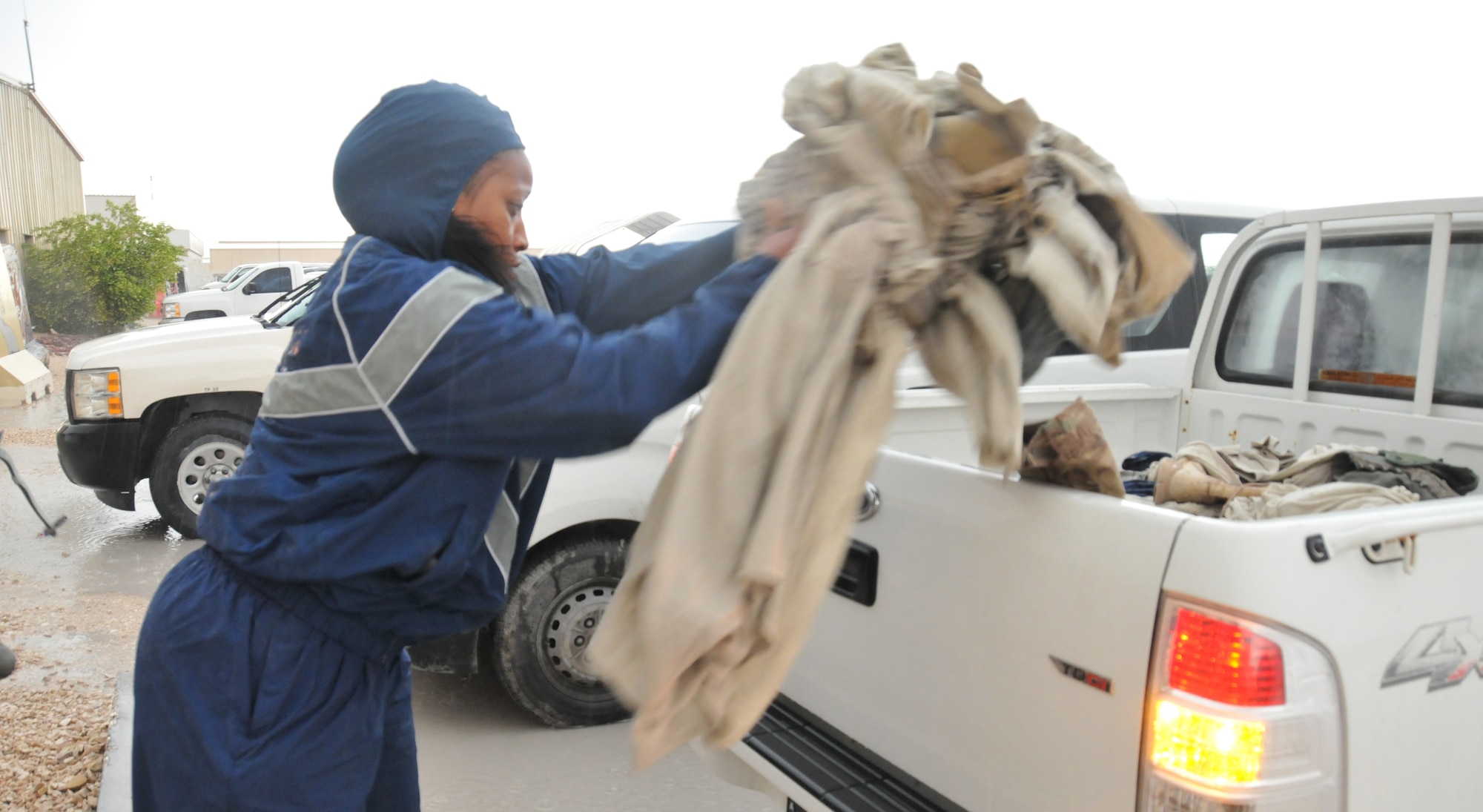 Master Sgt. Illeana Roebuck, 379th Expeditionary Air Evacuation Squadron respiratory therapist, collects uniforms from a uniform disposal bin Mar. 3 at Al Udeid Air Base, Qatar. Roebuck has been a volunteer for the Uniform Disposal Program for four months. There are 15 total bins located around base for AUAB personnel to utilize. (U.S. Air Force photo by Tech. Sgt. Terrica Y. Jones)
