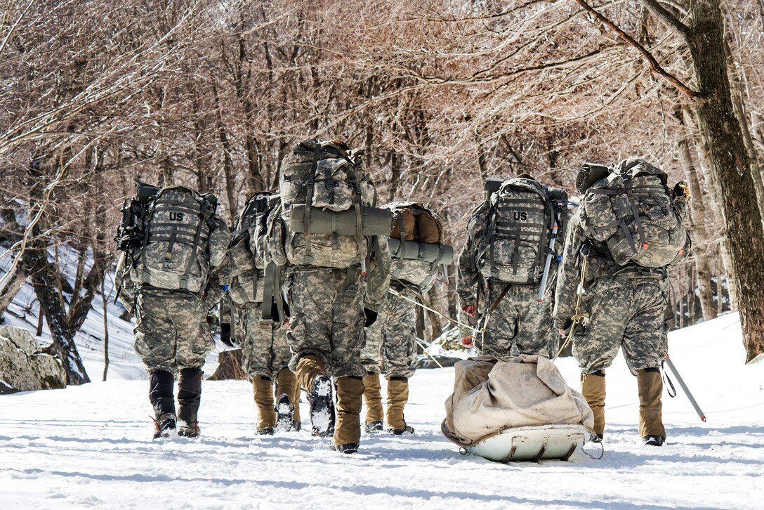 Soldiers tow a loaded sled to their established bivouac location at Smuggler's Notch, Jeffersonville, Vt., March 5, 2016. The soldiers are assigned to the Vermont National Guard’s Company A, 3rd Battalion, 172nd Infantry Regiment, 86th Infantry Brigade Combat Team, Mountain. Vermont Army National Guard photo by Staff Sgt. Chelsea Clark
