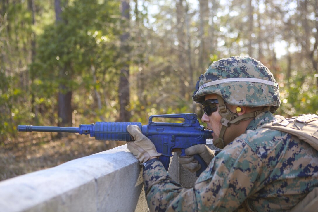 Lance Cpl. Arnaldo Avendano, a military policeman with 2nd Law Enforcement Battalion, takes a cover position during an assault course at Camp Lejeune, N.C., March 16, 2016. This drill is part of an annual training event to prepare them for combat situations when they are called upon to deploy. Marines took turns providing cover fire for their partner, allowing them to advance to the simulated enemy position. (U.S. Marine Corps photo by Lance Cpl. Aaron K. Fiala/Released)