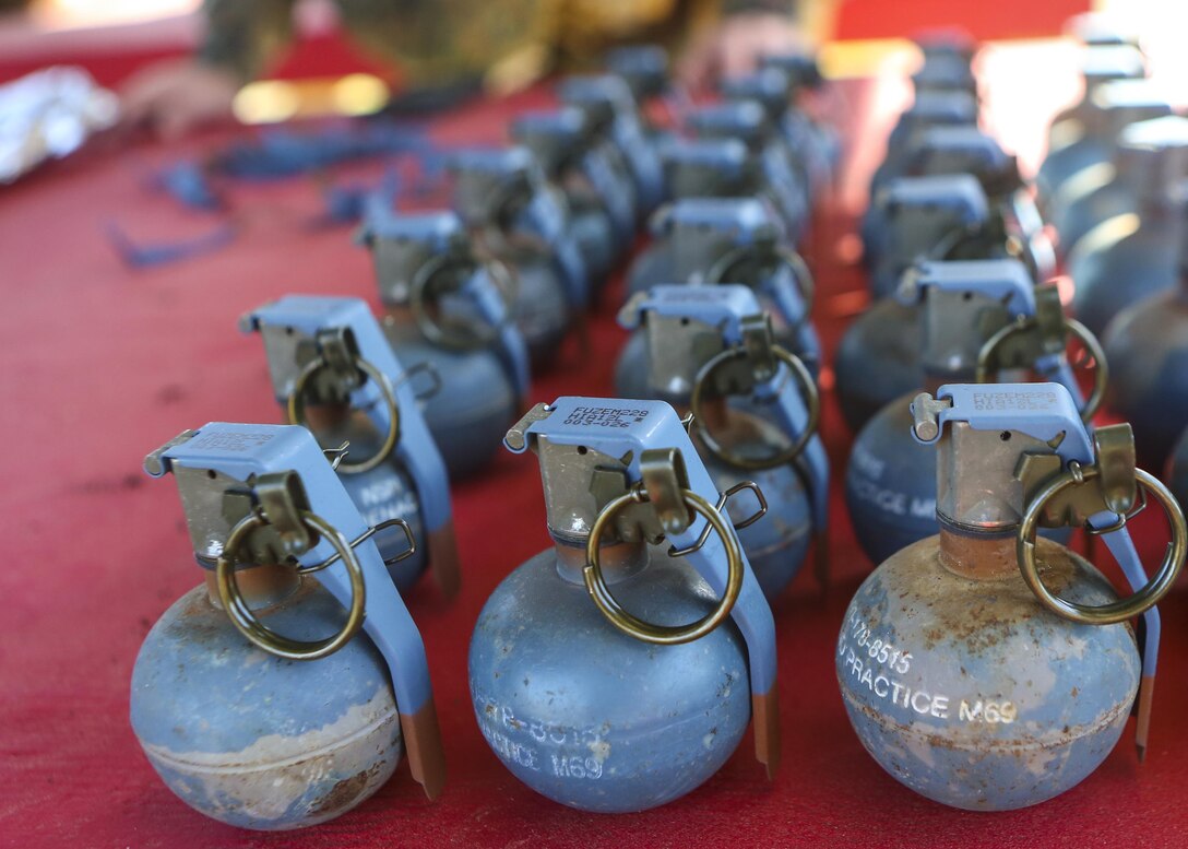 Inert grenades (dummy), non-exploding practice tools, sit on a table where Marines with 2nd Law Enforcement Battalion will pick them up before taking part in an assault course with grenade training at Camp Lejeune, N.C., March 16, 2016. This drill is part of an annual training event to prepare them for combat situations when they are called upon to deploy. Marines took turns providing cover fire for their partner, allowing them to throw a dummy grenade near the simulated enemy position (U.S. Marine Corps photo by Lance Cpl. Aaron K. Fiala/Released)