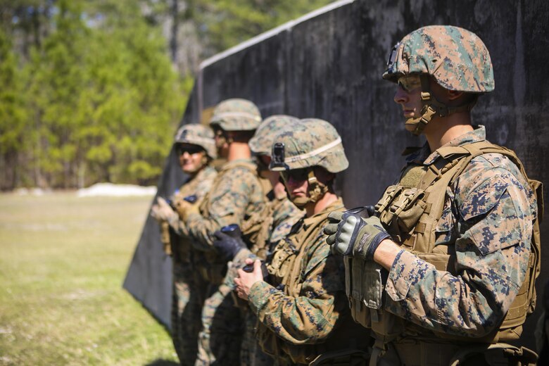 Marines with 2nd Law Enforcement Battalion hold a container with a grenade inside while they wait for their turn to throw it into the grenade range pits at Camp Lejeune, N.C., March 16, 2016. This drill is part of an annual training event to prepare them for combat situations when they are called upon to deploy. (U.S. Marine Corps photo by Lance Cpl. Aaron K. Fiala/Released)