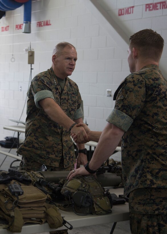 Commandant of the Marine Corps Gen. Robert B. Neller greets a critical skills operator with U.S. Marine Corps Forces, Special Operations Command (MARSOC), during his visit at Stone Bay aboard Marine Corps Base Camp Lejeune, N.C., March 17, 2016. The CSO briefed the Commandant on the various weapons systems and protective equipment used by MARSOC Marines during training and missions.