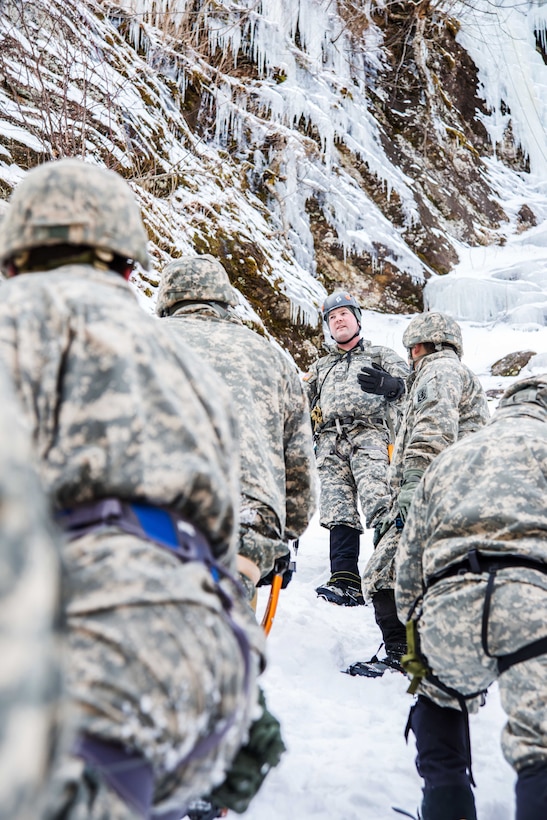 Army Sgt. Jeffrey Deslauries, center, briefs safety and proper vertical ice ascending techniques to his soldiers at Smuggler's Notch, Jeffersonville, Vt., March 5, 2016. Deslauries is assigned to Company A, 3rd Battalion, 172nd Infantry Regiment, 86th Infantry Brigade Combat Team, Mountain. Vermont Army National Guard photo by Staff Sgt. Chelsea Clark