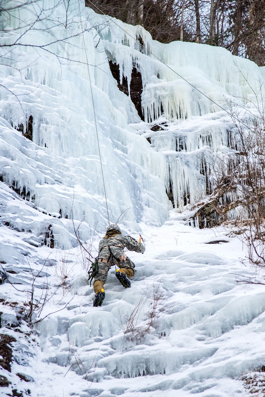 A soldier climbs an ice wall during top rope training at Smuggler's Notch, Jeffersonville, Vt., March 5, 2016. Vermont Army National Guard photo by Staff Sgt. Chelsea Clark