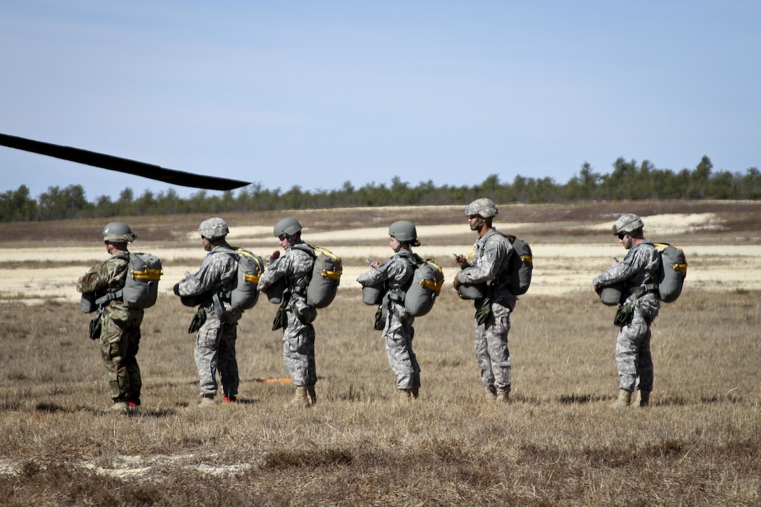 Paratroopers stand in line before boarding a UH-60 Black Hawk helicopter before participating in a parachute jump over Coyle drop zone on Joint Base McGuire-Dix-Lakehurst, N.J., March 12, 2016. New Jersey Air National Guard photo by Tech. Sgt. Matt Hecht