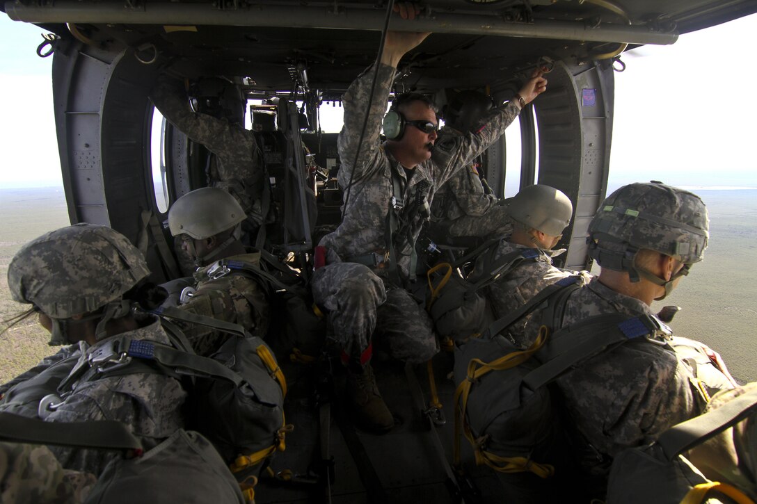 Paratroopers sit inside a UH-60 Black Hawk helicopter before a parachute jump over Coyle drop zone on Joint Base McGuire-Dix-Lakehurst, N.J., March 12, 2016. New Jersey Air National Guard photo by Tech. Sgt. Matt Hecht