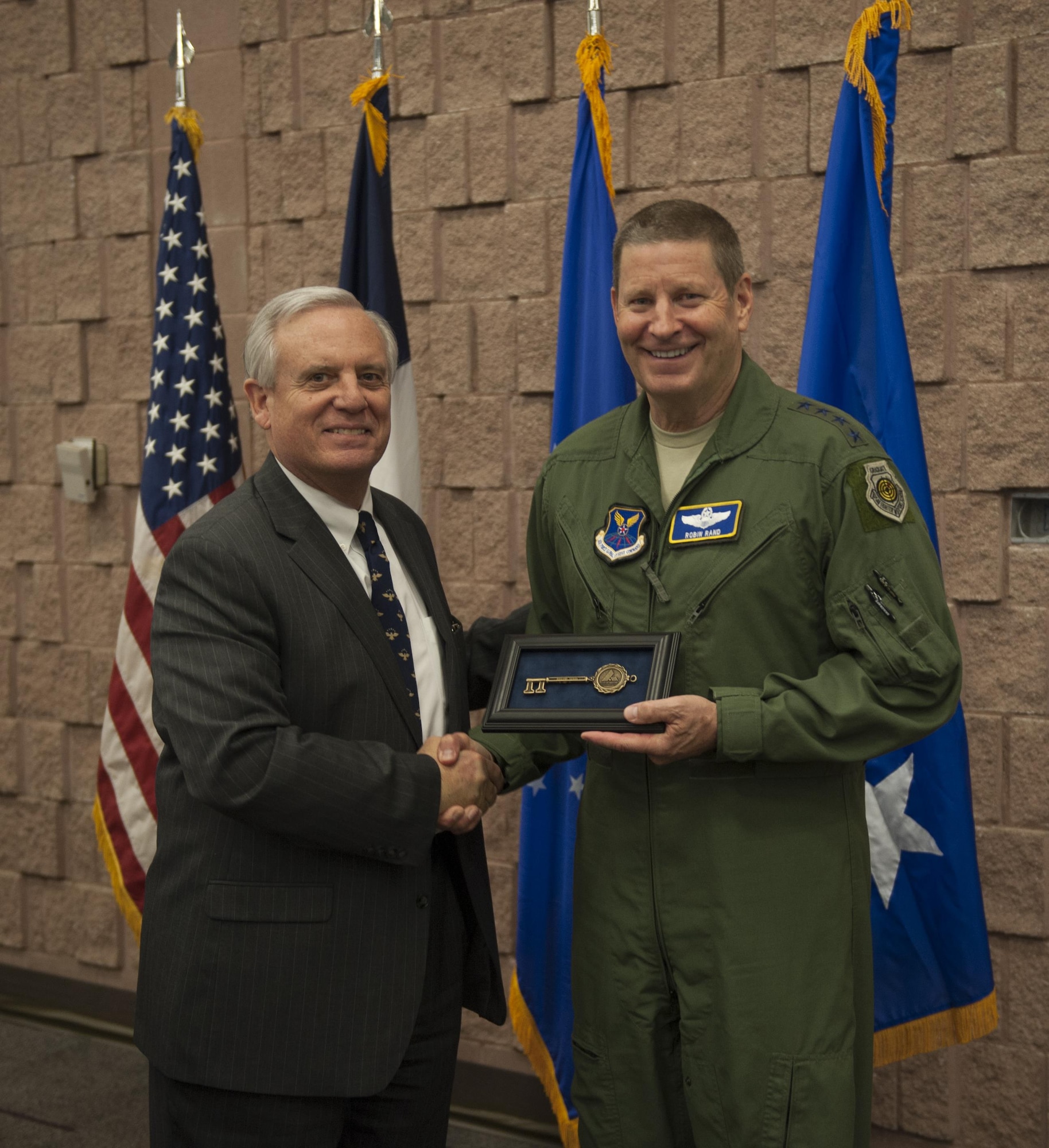 Mayor of Abilene Norm Archibald presents the key to the city to Gen. Robin Rand, AFGSC commander, March 8, 2016, during a Military Affairs Committee luncheon in Abilene, Texas. The presentation of the key honored the strong partnership between the city and Dyess Air Force Base. (U.S. Air Force photo by Airman 1st Class Quay Drawdy/Released)
