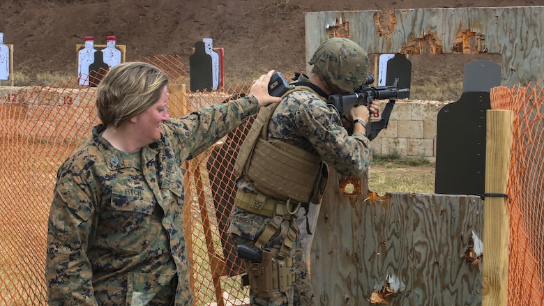 Gunnery Sgt. Tanya Fitch, a small arms instructor with Headquarters Battalion, times Lance Cpl. Drew Dodd, a rifleman with Fox Company, 2nd Battalion, 3rd Marine Regiment, during the Pacific Combat Shooting Match at the Kaneohe Bay Range Training Facility aboard Marine Corps Base Hawaii, March 16, 2016. Teams from different units used various weapons and tactics to achieve the fastest time possible on different courses of fire, while earning points for awards during the competition. Marines from the Marine Corps Combat Shooting Team instructed and gave advice to the Marines participating in the event.