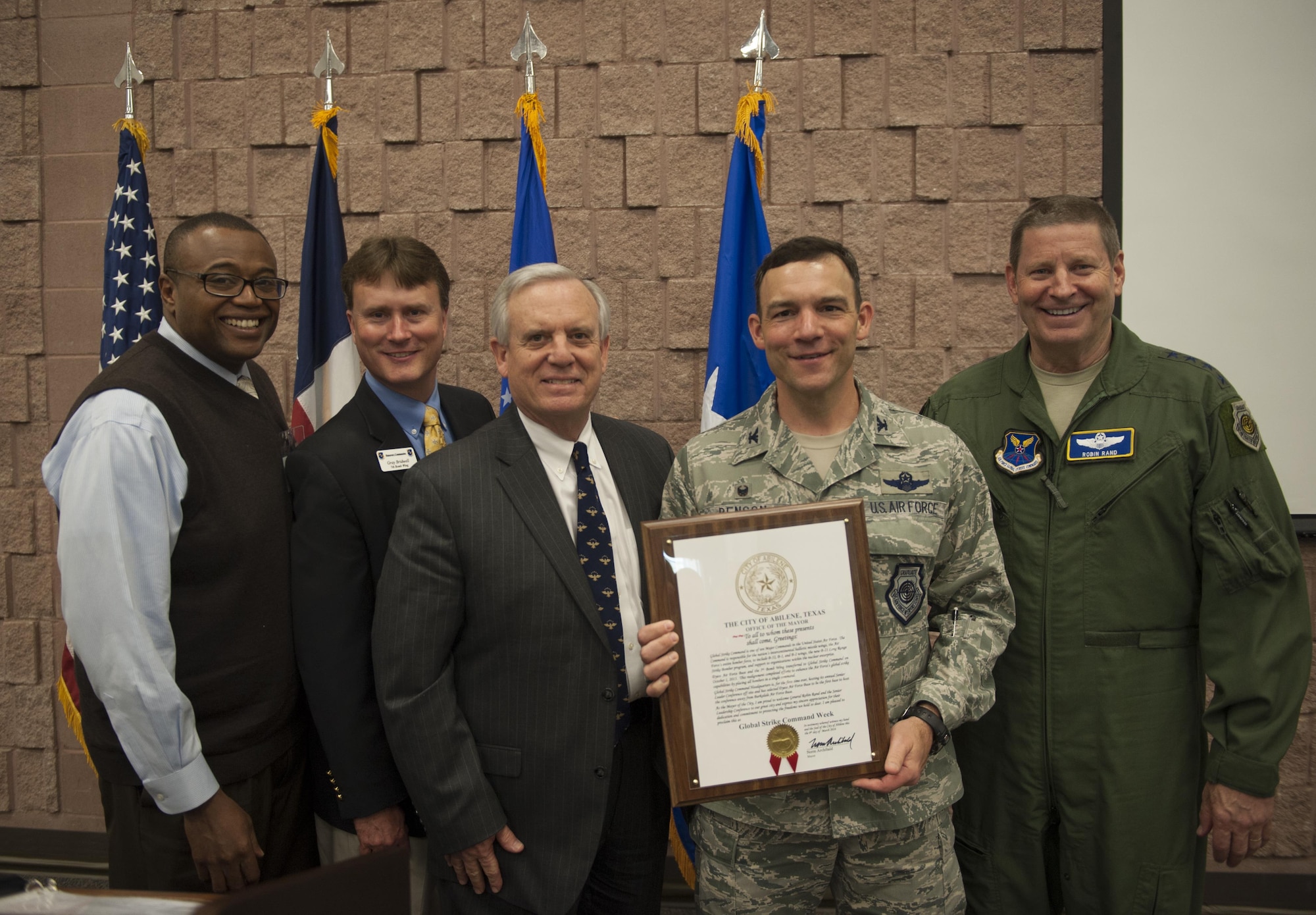 Abilene city councilman Anthony Williams, Abilene Military Affairs Committee chairman Gray Bridwell, and Abilene mayor Norm Archibald present Col. David Benson, 7th Bomb Wing commander, and Gen. Robin Rand, AFGSC commander, with a proclamation declaring March 6-12 “Global Strike Week” March 9, 2016, at the Civic Center in Abilene, Texas. The declaration came as a tribute to Dyess Air Force Base being the chosen location for the Air Force Global Strike Command's Senior Leader Conference. (U.S. Air Force photo by Airman 1st Class Quay Drawdy/Released)