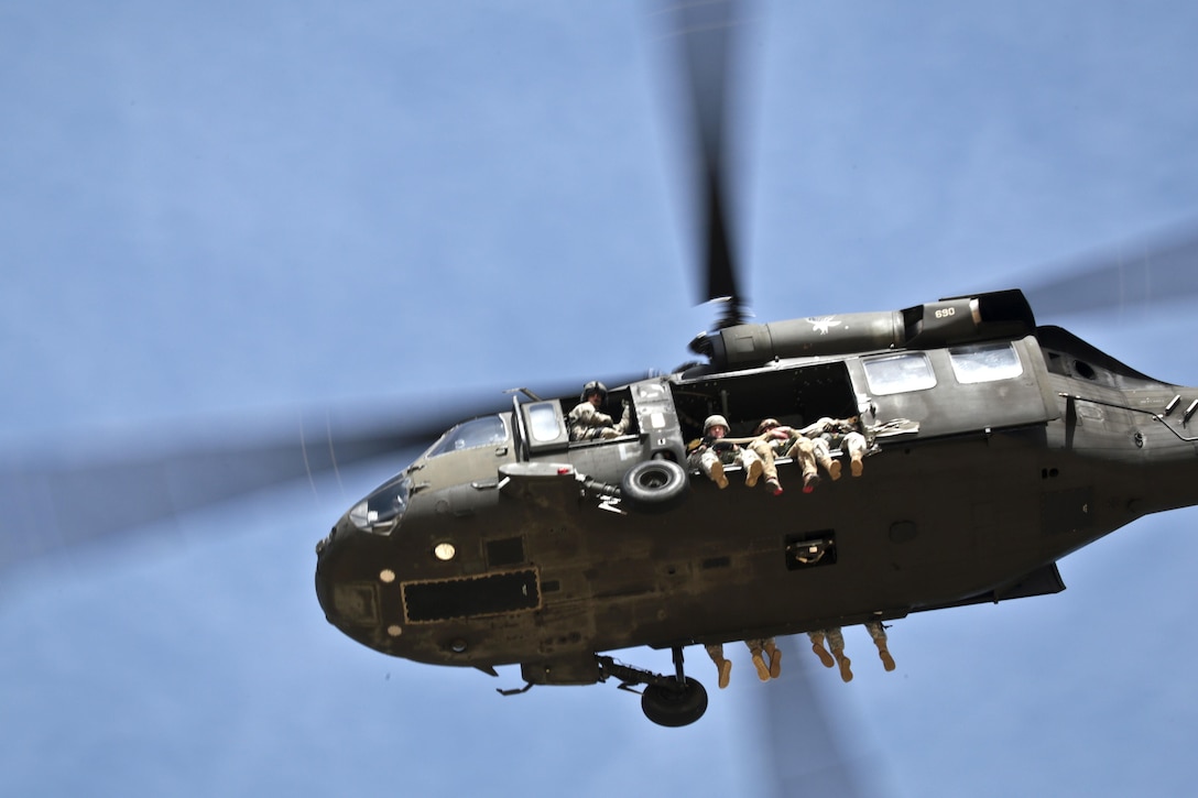 A UH-60 Black Hawk helicopter lifts off with paratroopers to participate in parachute jump training over Coyle drop zone on Joint Base McGuire-Dix-Lakehurst, N.J., March 12, 2016. New Jersey Air National Guard photo by Tech. Sgt. Matt Hecht