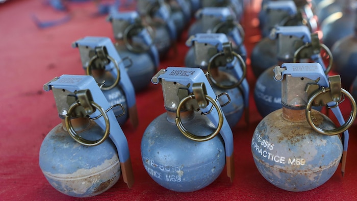Inert grenades (dummy), non-exploding practice tools, sit on a table where Marines with 2nd Law Enforcement Battalion will pick them up before taking part in an assault course with grenade training at Marine Corps Base Camp Lejeune, N.C., March 16, 2016. This drill is part of an annual training event to prepare them for combat situations when they are called upon to deploy. Marines took turns providing cover fire for their partner, allowing them to throw a dummy grenade near the simulated enemy position.