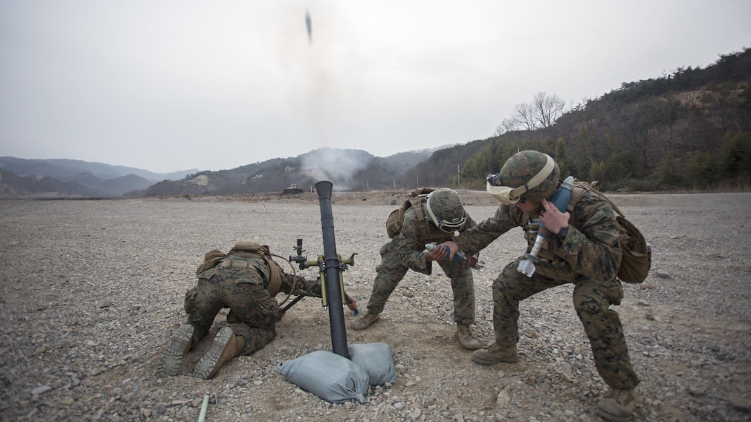 From left, U.S. Marine Corps Lance Cpl. Dave Hermansen and Lance Cpl. Jabril Giannotti, mortarmen, and Sgt. Jack Williams, a squad leader, all assigned to Weapons Co., Battalion Landing Team, 1st Battalion 5th Marines, 31st Marine Expeditionary Unit, fire a 81mm training mortar with the M252A2 mortar system during Ssang Yong 16 at Suseongri, South Korea, March 15, 2016. Ssang Yong familiarizes American armed forces with the Korean Peninsula and contributes to the security and stability of the Asia-Pacific region. Hermansen is a native of Westbrook, Connecticut. Giannotti is a native of Highland Park, New Jersey. Williams is a native of Pilot Point, Texas.