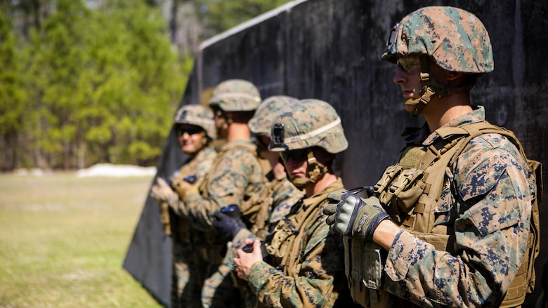 Marines with 2nd Law Enforcement Battalion hold a container with a grenade inside while they wait for their turn to throw it into the grenade range pits at Marine Corps Base Camp Lejeune, N.C., March 16, 2016. This drill is part of an annual training event to prepare them for combat situations when they are called upon to deploy.