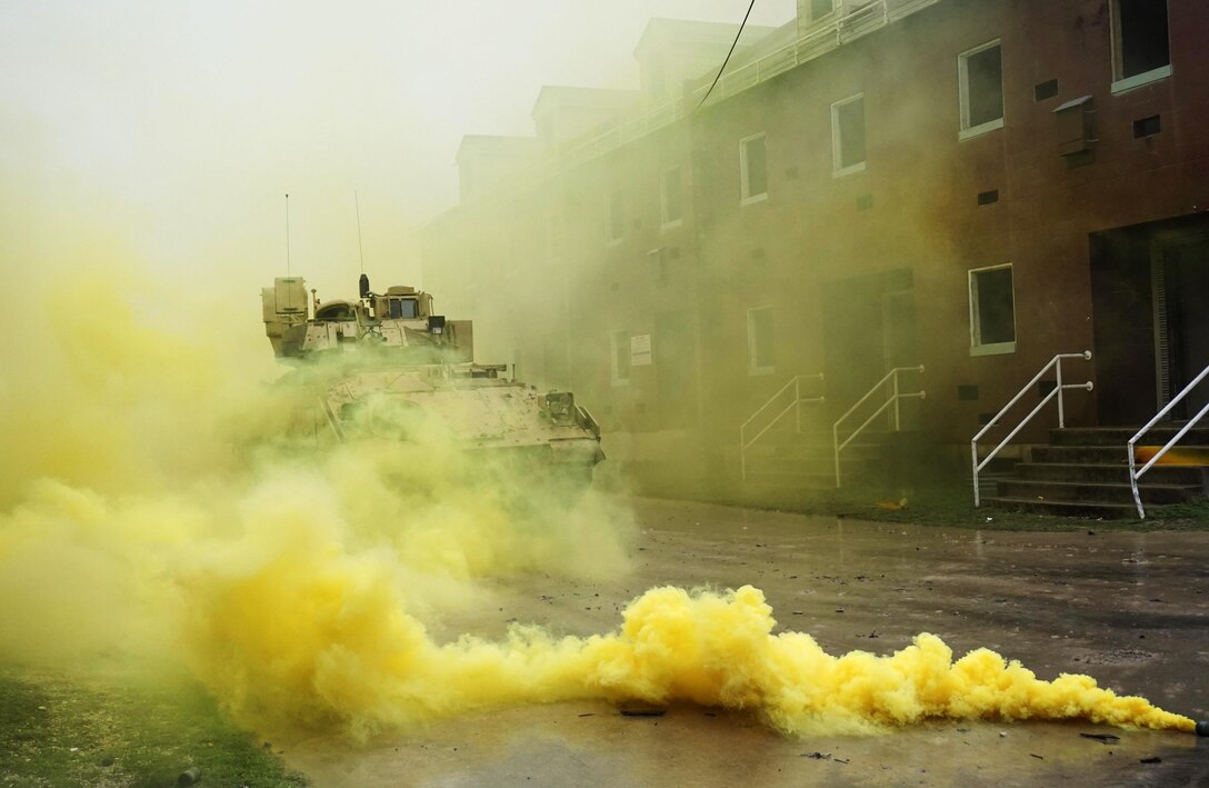 A M2A3 Bradley fighting vehicle moves through the cover of smoke to dismount soldiers during urban terrain training on Fort Hood, Texas, March 10, 2016. Army photo by Sgt. Brandon Banzhaf