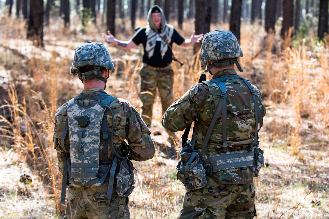 Soldiers participate in a key leader engagement while on patrol during a training exercise that's part of the Army Reserve Medical Command's 2016 Best Warrior competition on Fort Gordon, Ga., March 8,  2016. Army photo by Sgt. 1st Class Brian Hamilton