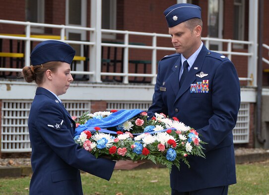 During a remembrance ceremony to honor six Airmen who made the ultimate sacrifice 35 years ago, U.S. Air Force Airman Corale Cobb, 45th Reconnaissance Squadron, and U.S. Air Force Col. Brian Thomas, 45th RS commander, place a wreath next to a monument outside the squadron that memorializes them March 15, 2016, at Offutt Air Force Base, Neb. The Airmen lost their lives when an RC-135S Cobra Ball 664 crashed upon landing at Shemya Air Force Base, Alaska. (U.S. Air Force photo by Kendra Williams)
