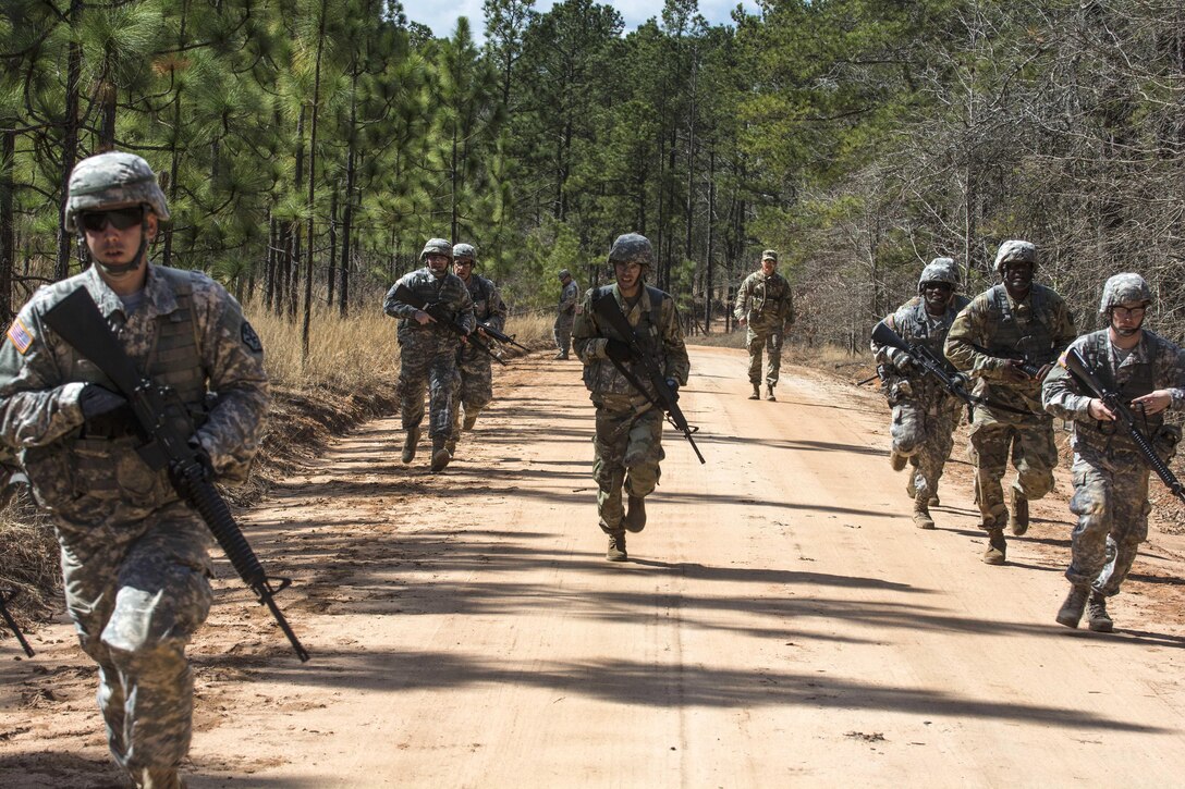 Soldiers react to indirect contact while on patrol during a training exercise that's part of the Army Reserve Medical Command's 2016 Best Warrior competition on Fort Gordon, Ga., March 8, 2016. Army photo by Sgt. 1st Class Brian Hamilton