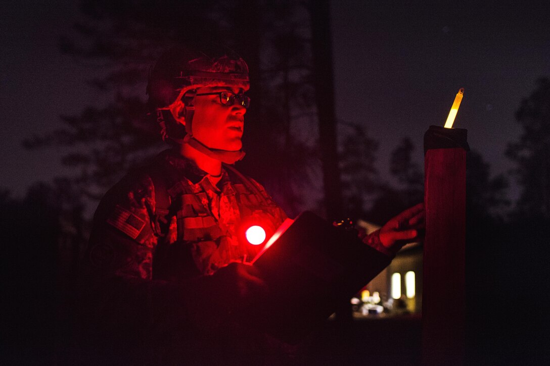 Army Sgt. Abraham Amabisca checks his azimuth during the night land navigation course that's part of the Army Reserve Medical Command's 2016 Best Warrior competition on Fort Gordon, Ga., March 8, 2016. Amabisca is assigned to the Medical Readiness Training Command, Army Reserve Medical Command. Army photo by Sgt. 1st Class Brian Hamilton