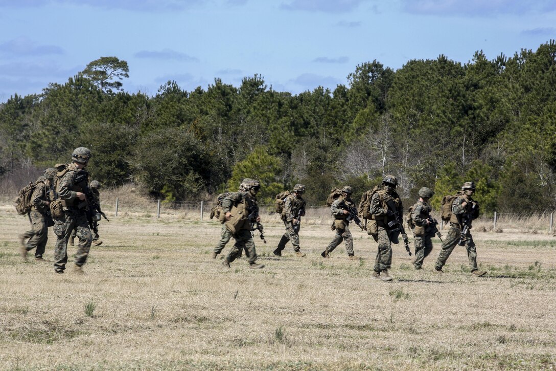 Marines advance to their next objective across a landing zone during a field exercise on Camp Lejeune, N.C., March 10, 2016. Marine Corps photo by Cpl. Paul S. Martinez