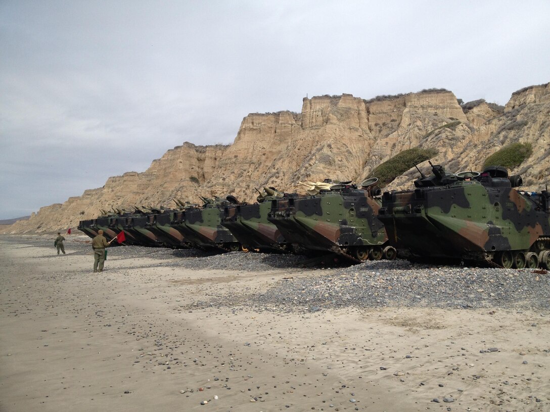 Tracks are staged on the beach before students commence basic water training. Under the guidance and supervision of the instructors, the students will drive the AAVs into the water at Camp Pendleton.