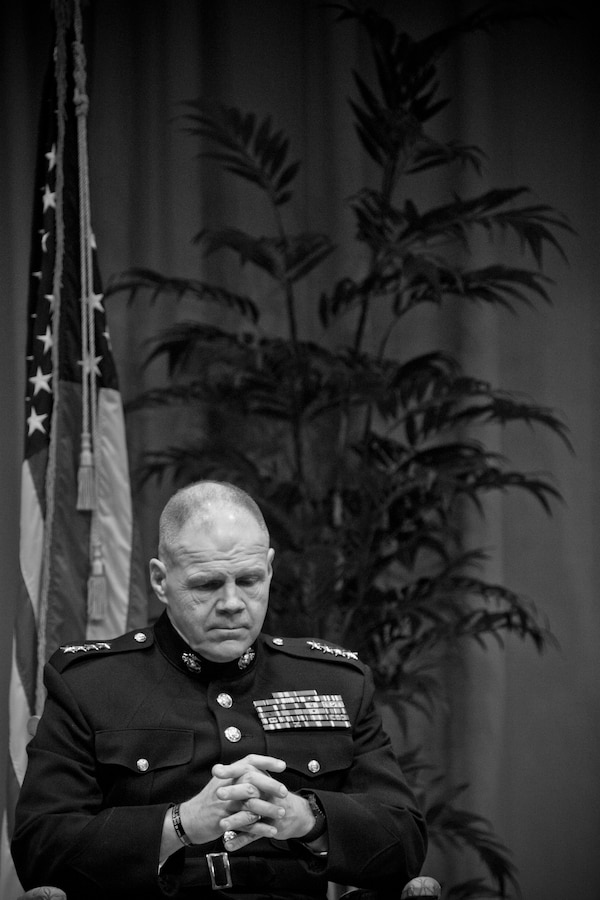 Commandant of the Marine Corps Gen. Robert B. Neller listens to a prayer during an award ceremony at Tallahassee, Fla., March 18, 2016. Neller presented retired U.S. Marine Lt. Gen. Lawrence F. Snowden, an Iwo Jima veteran, with the Department of Defense Medal for Distinguished Public Service and Navy Distinguished Public Service Award. (U.S. Marine Corps photo illustration by Staff Sgt. Gabriela Garcia/Released)