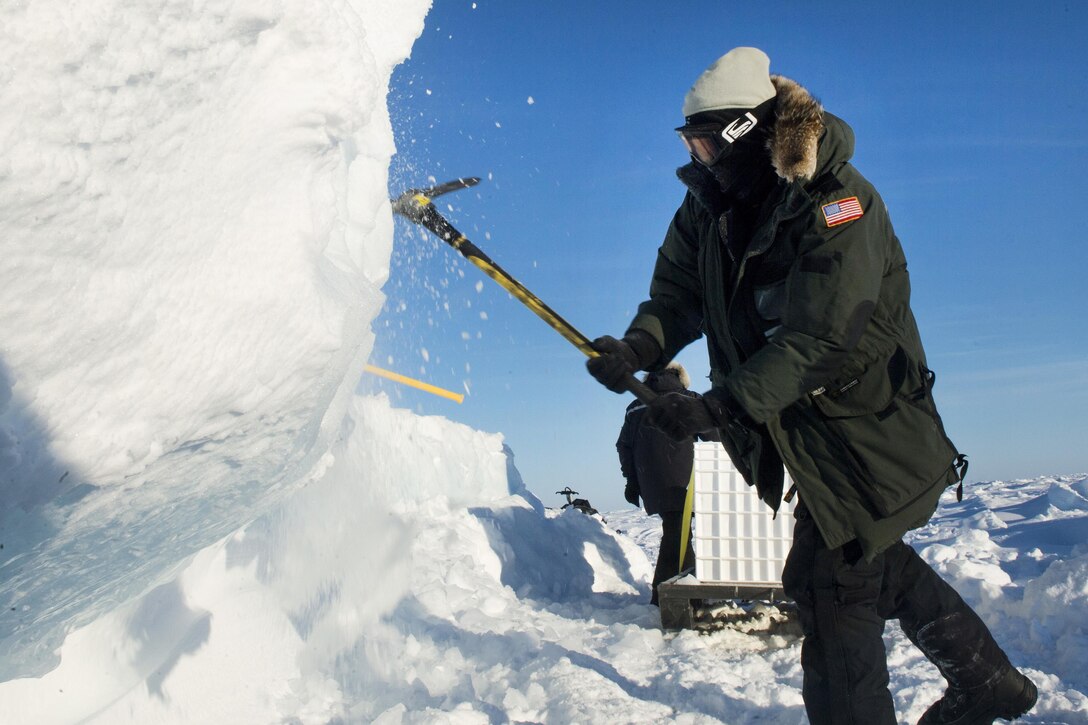 Navy Chief Phil Alampi mines ice that will be melted down and used as drinking water during Ice Exercise 2016 at Ice Camp Sargo, Arctic Circle, March 8, 2016. Alampi is an electrician's mate assigned to the Arctic Submarine Laboratory. Navy photo by Petty Officer 2nd Class Tyler N. Thompson